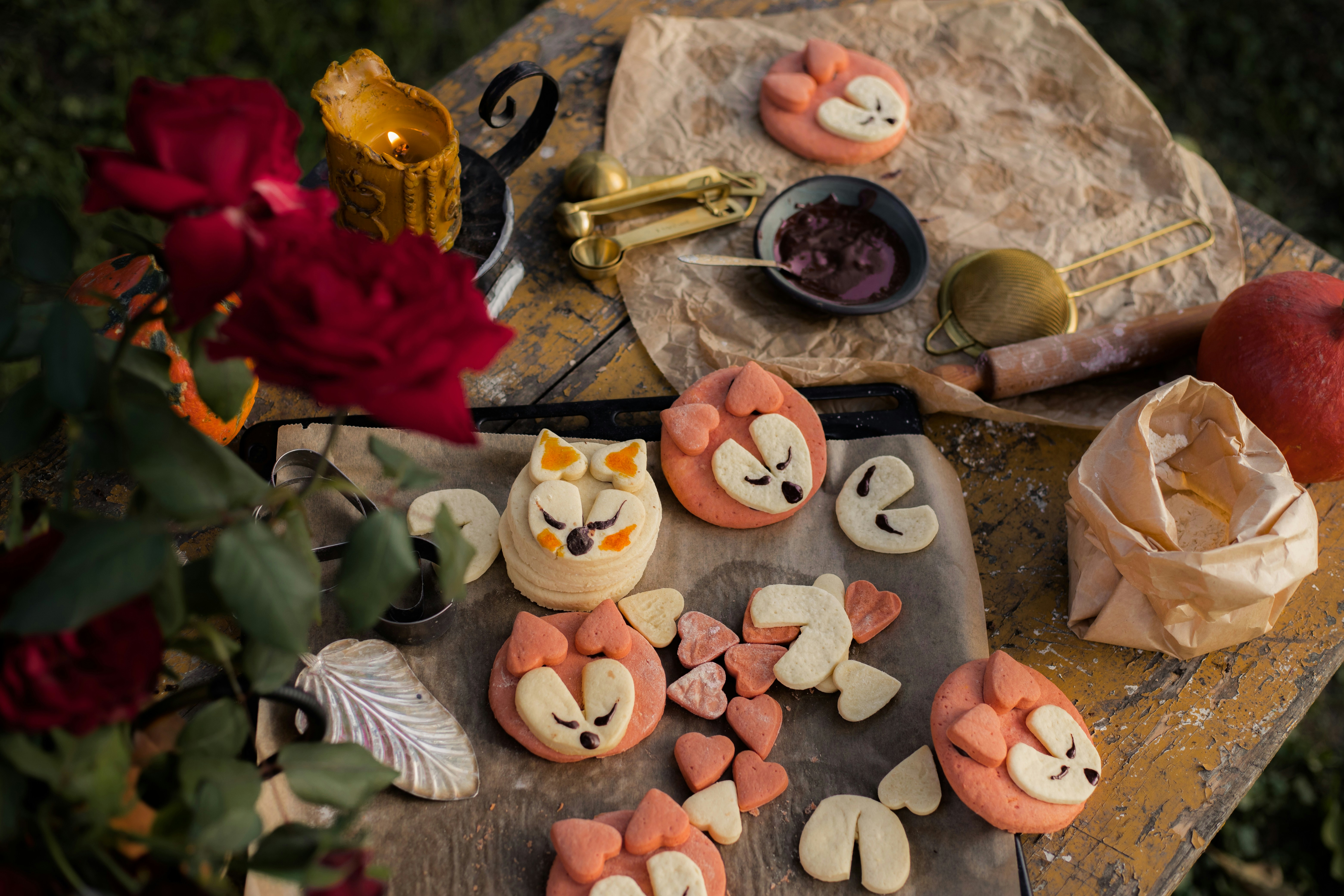 a wooden table topped with cookies covered in icing