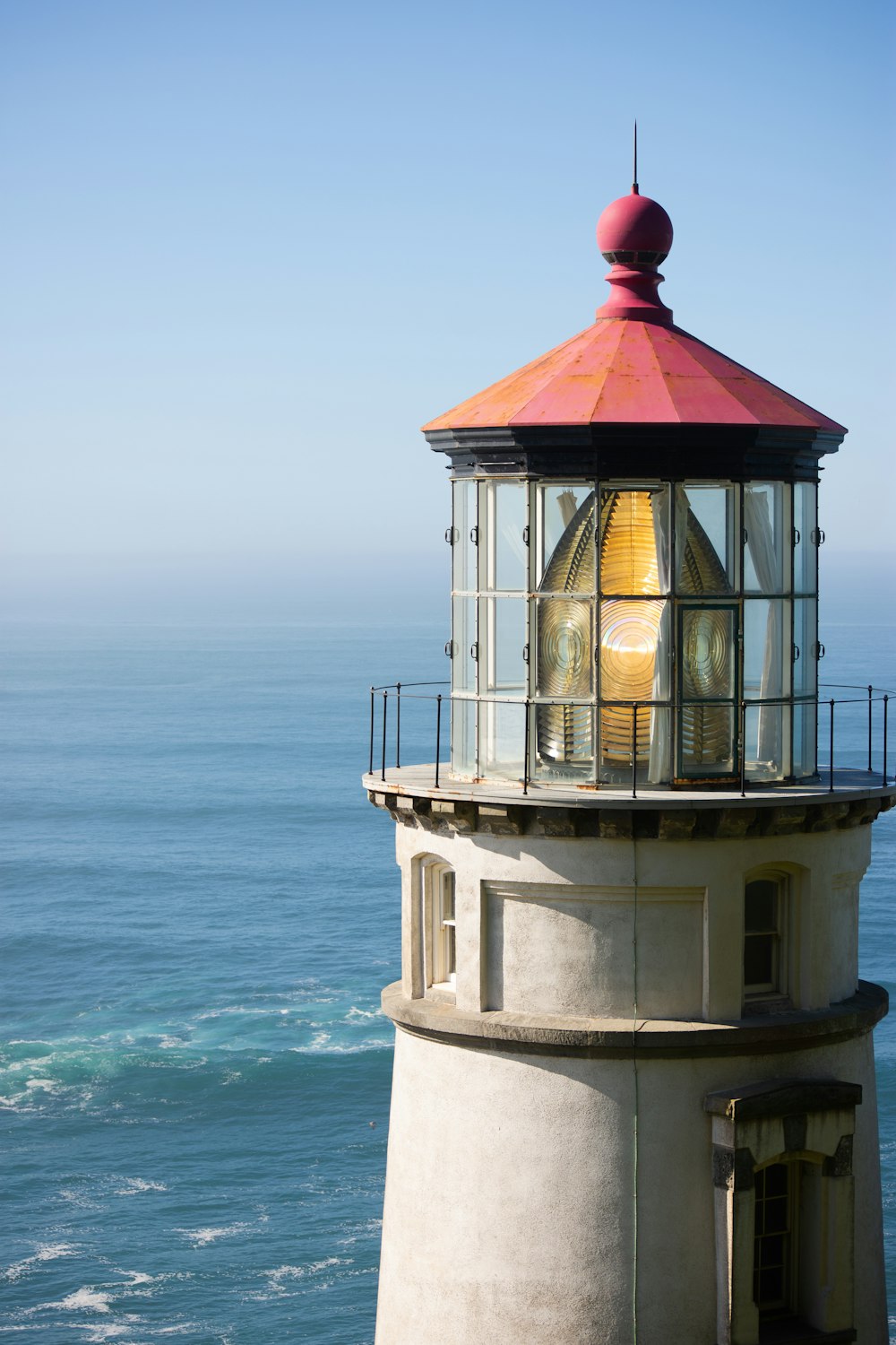 a light house sitting on top of a cliff next to the ocean