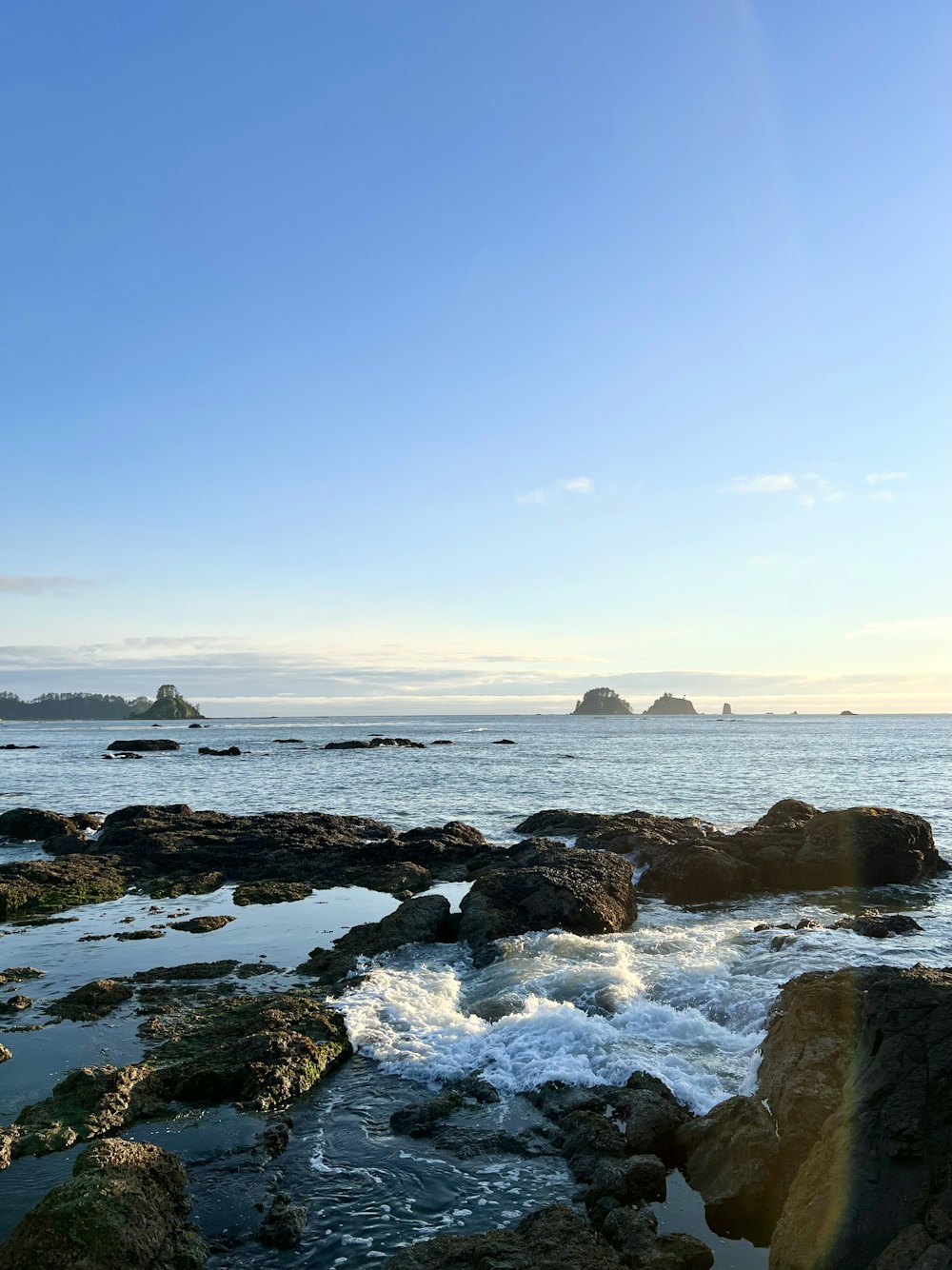 a view of a body of water with rocks in the foreground