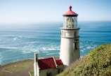 a lighthouse on a cliff overlooking the ocean