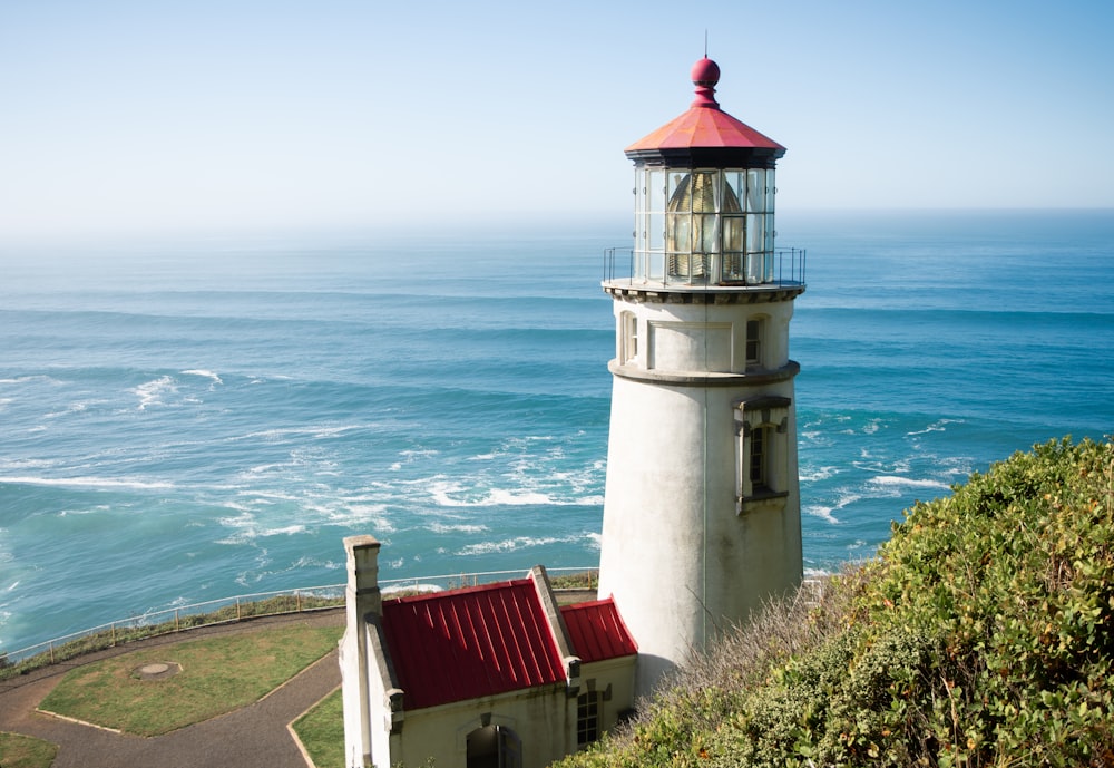 a lighthouse on a cliff overlooking the ocean