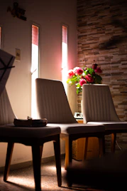 Warm and inviting therapy consultation room with natural light and cozy seating.