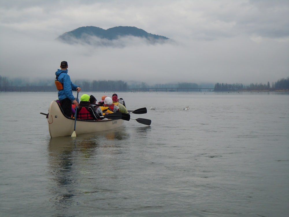 a group of people in a canoe on a lake