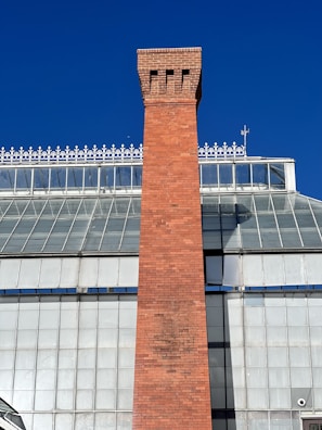 a tall brick tower with a clock on top of it