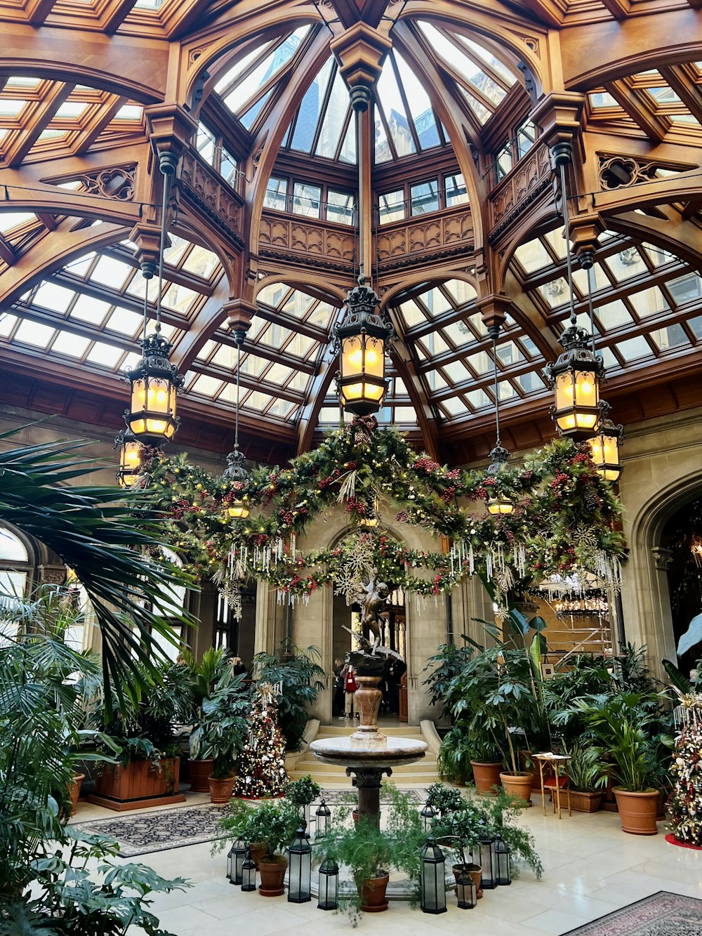 the inside of a building with a lot of potted plants