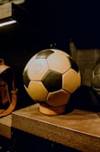 a soccer ball sitting on top of a wooden shelf