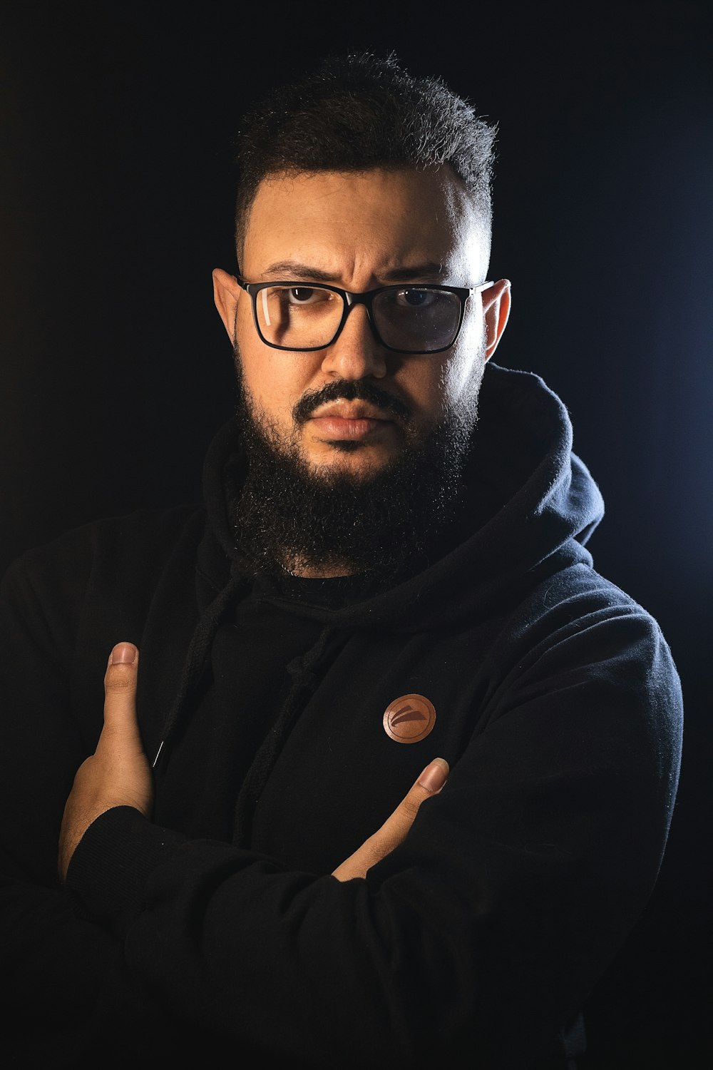 a man with a beard and glasses posing for a picture