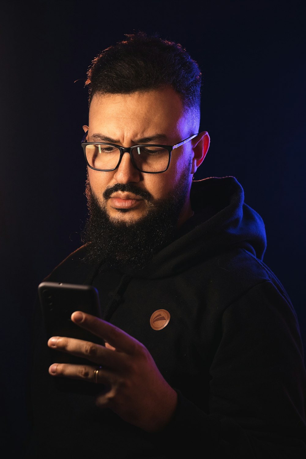 a man with a beard using a cell phone