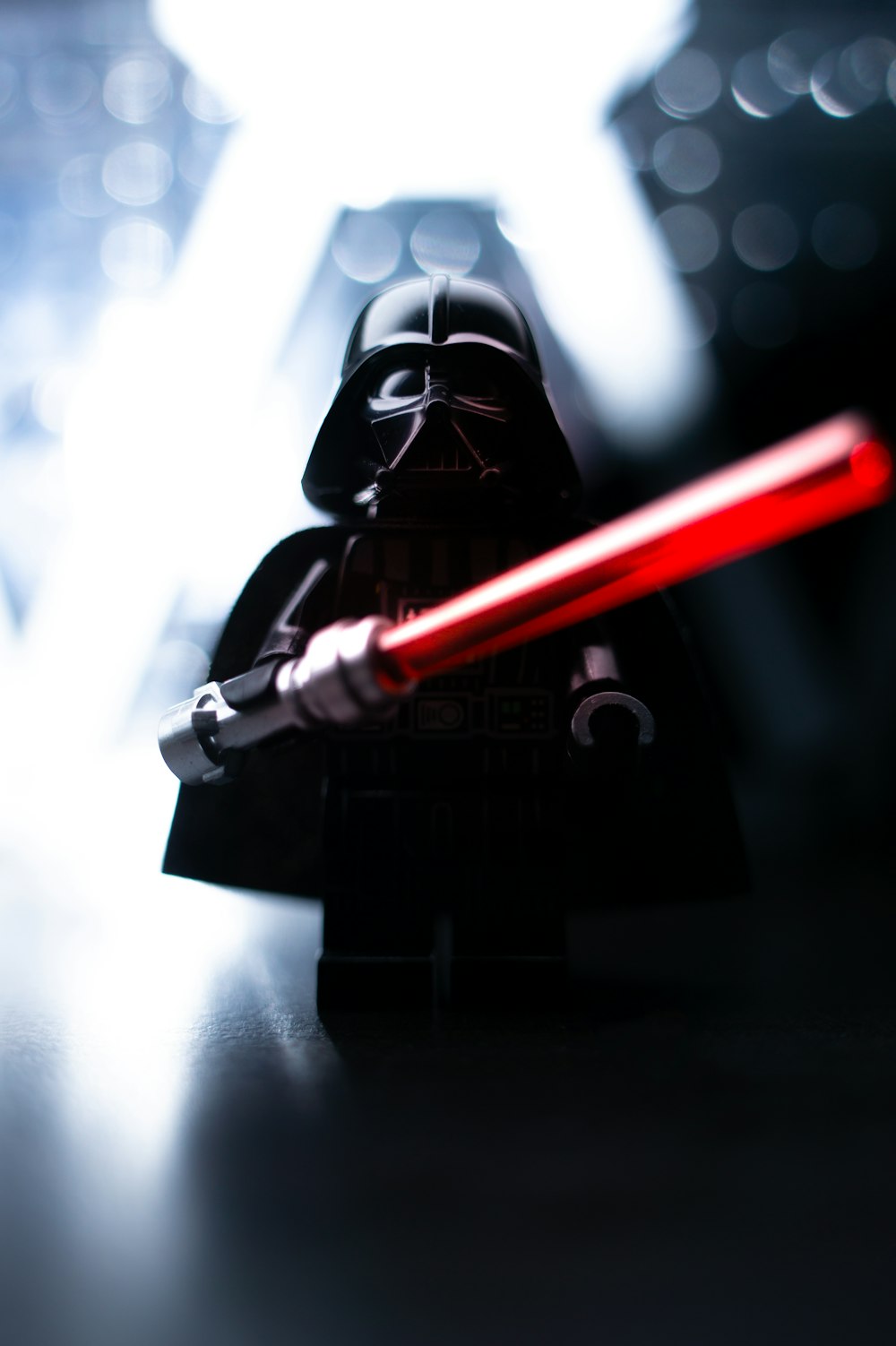 a lego darth vader with a red light saber
