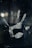 A blurred handprint, possibly on glass or a reflective surface, with smudges and fingerprints visible. The background is dark, enhancing the visibility of the handprint.