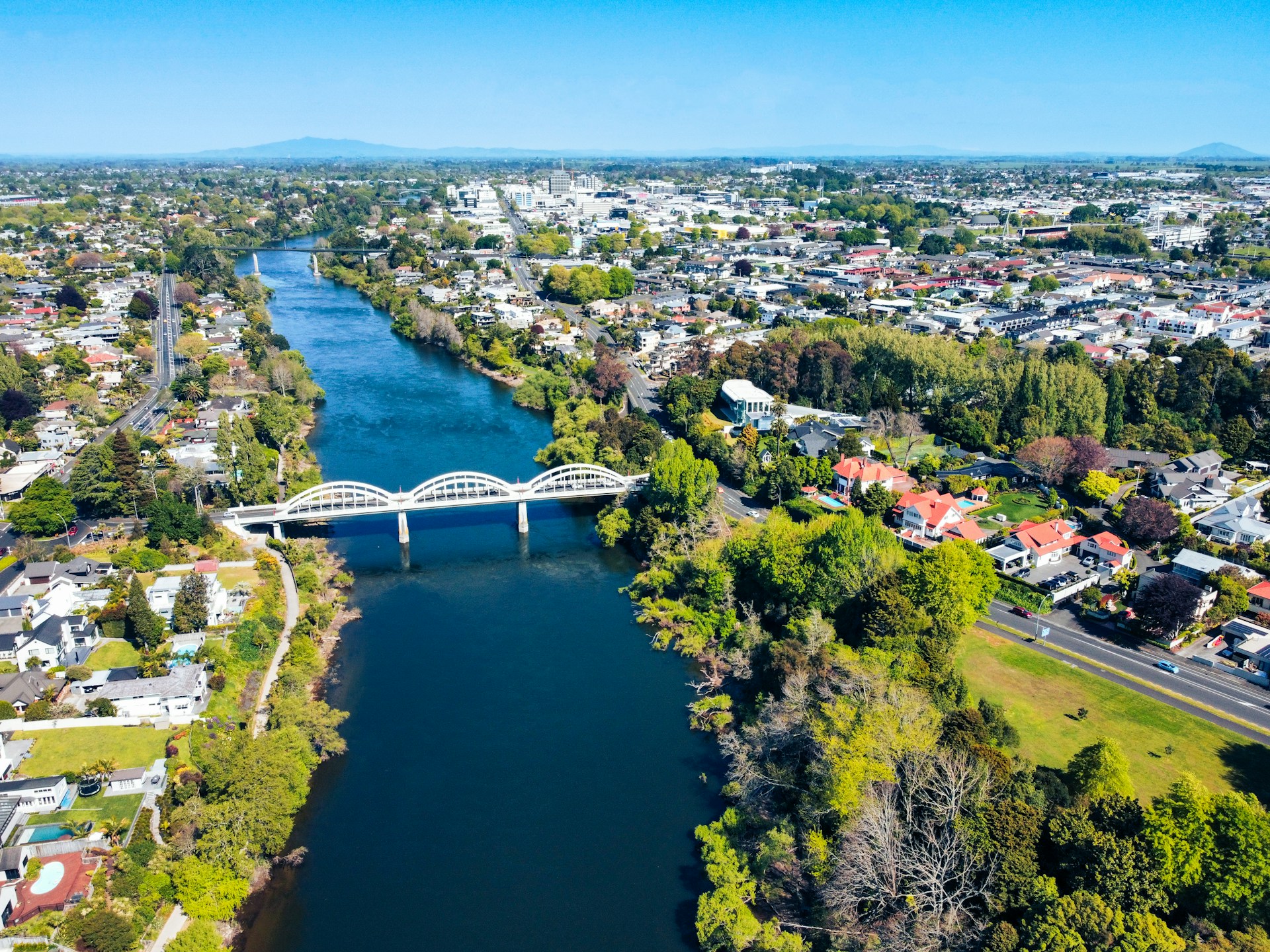 an aerial view of a river running through a city