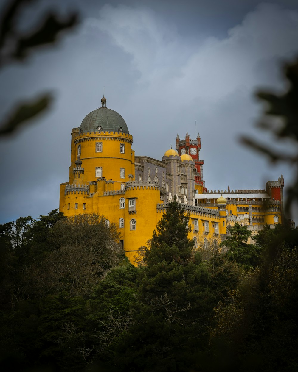 a large yellow castle with a clock tower on top of it