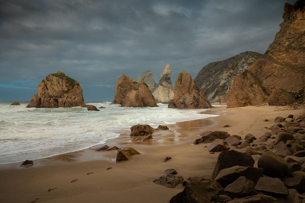 a beach with rocks and a body of water