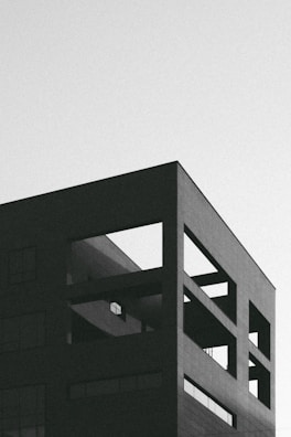 High-resolution render of a modern building exterior with sharp angles and minimalist aesthetic.