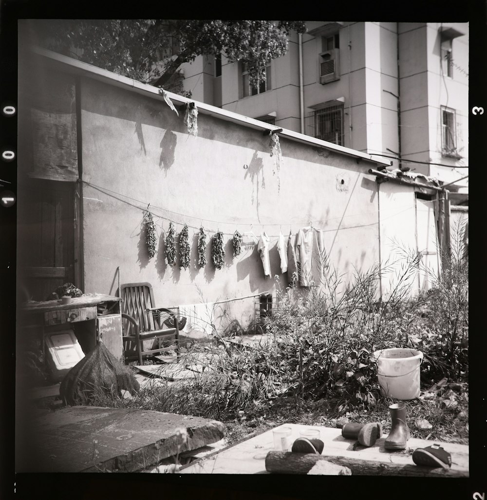 a black and white photo of clothes hanging on a clothes line