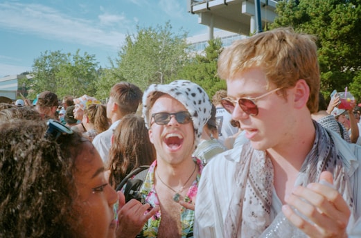 A lively group of friends celebrating at a sunny Spanish beach party.