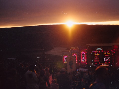 Outdoor concert stage with lighting and sound equipment at sunset
