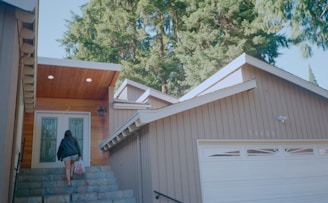 A person opening the door of a house.