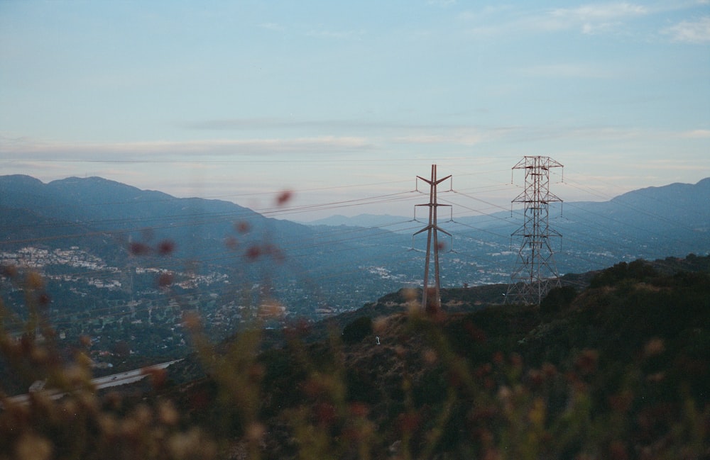 a view of a mountain with power lines in the foreground