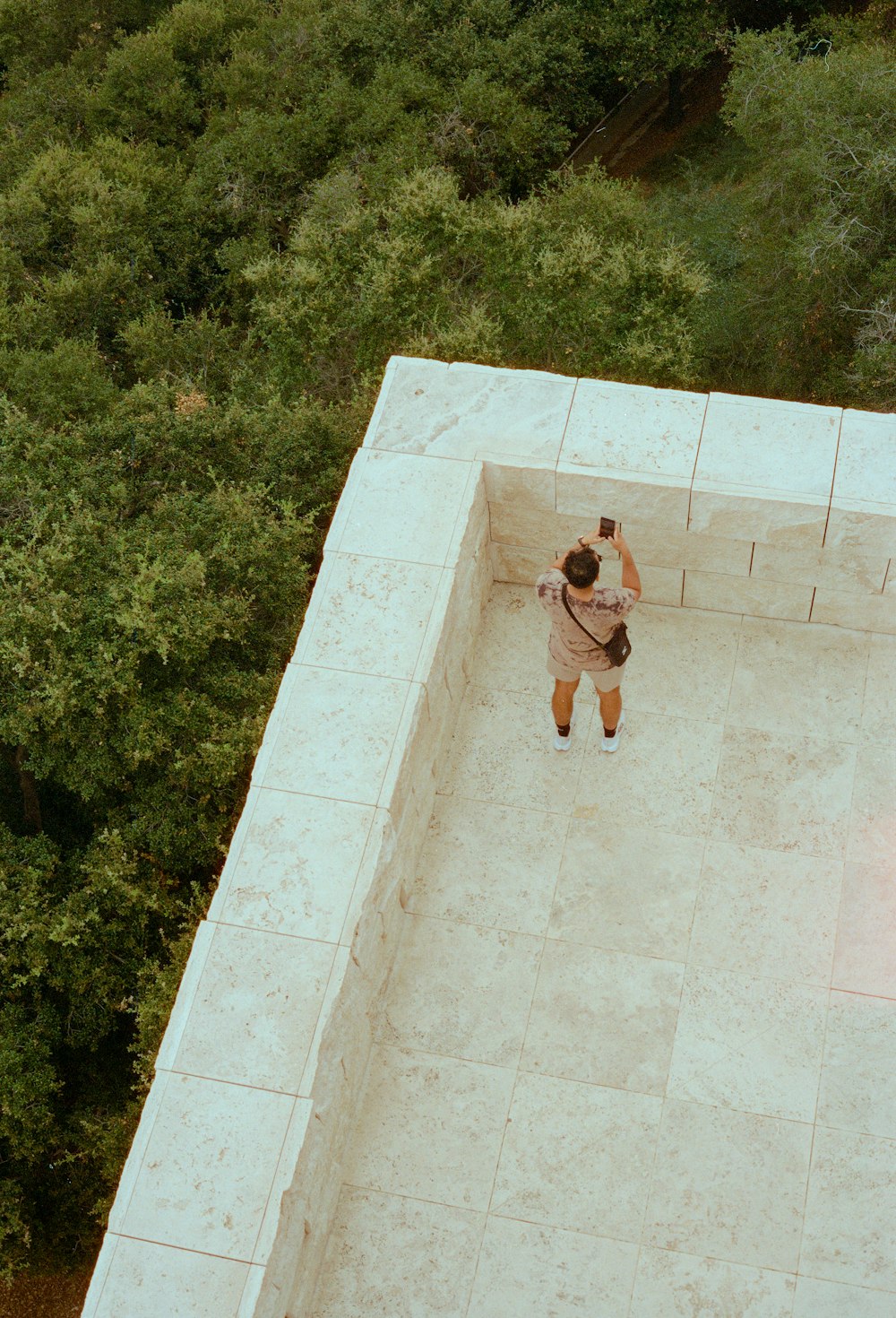 a man taking a picture of himself in a pool