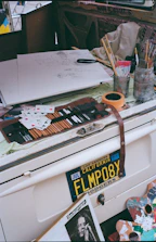 A cozy corner with art supplies and unfinished colorful paintings waiting for inspiration.