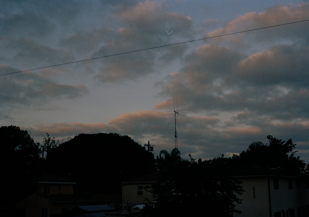 a view of a cloudy sky with a telephone pole in the distance
