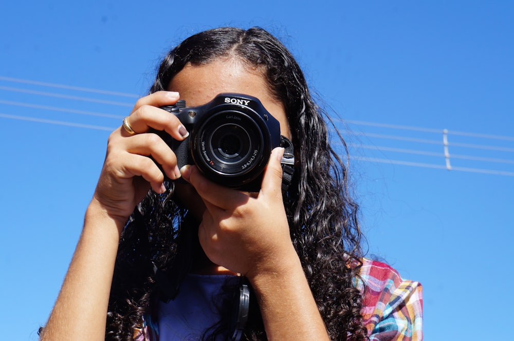 a woman taking a picture with a camera