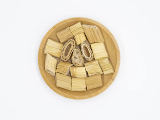 Close-up of eco-friendly sugarcane bagasse plates stacked neatly on a wooden table.