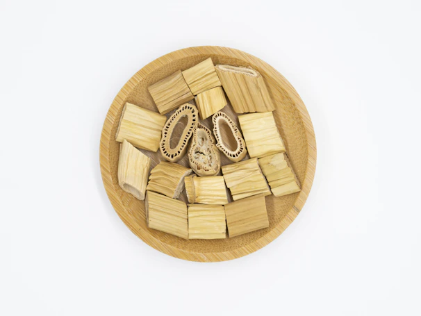 Close-up of eco-friendly sugarcane bagasse plates stacked neatly on a wooden table.