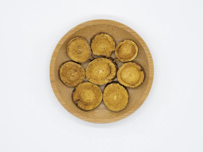Close-up of medicinal mushrooms arranged with ritual objects on a wooden table.