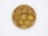 Seven circular, beige and brown objects that appear to be dried mushroom slices are arranged on a round, wooden plate. The background is plain white.