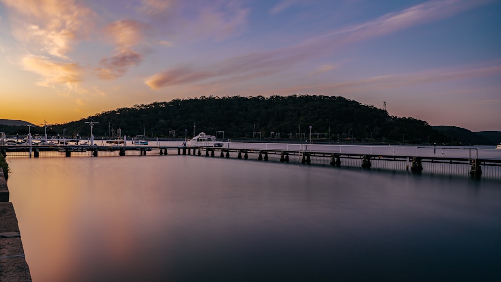 a body of water with a dock in the middle of it