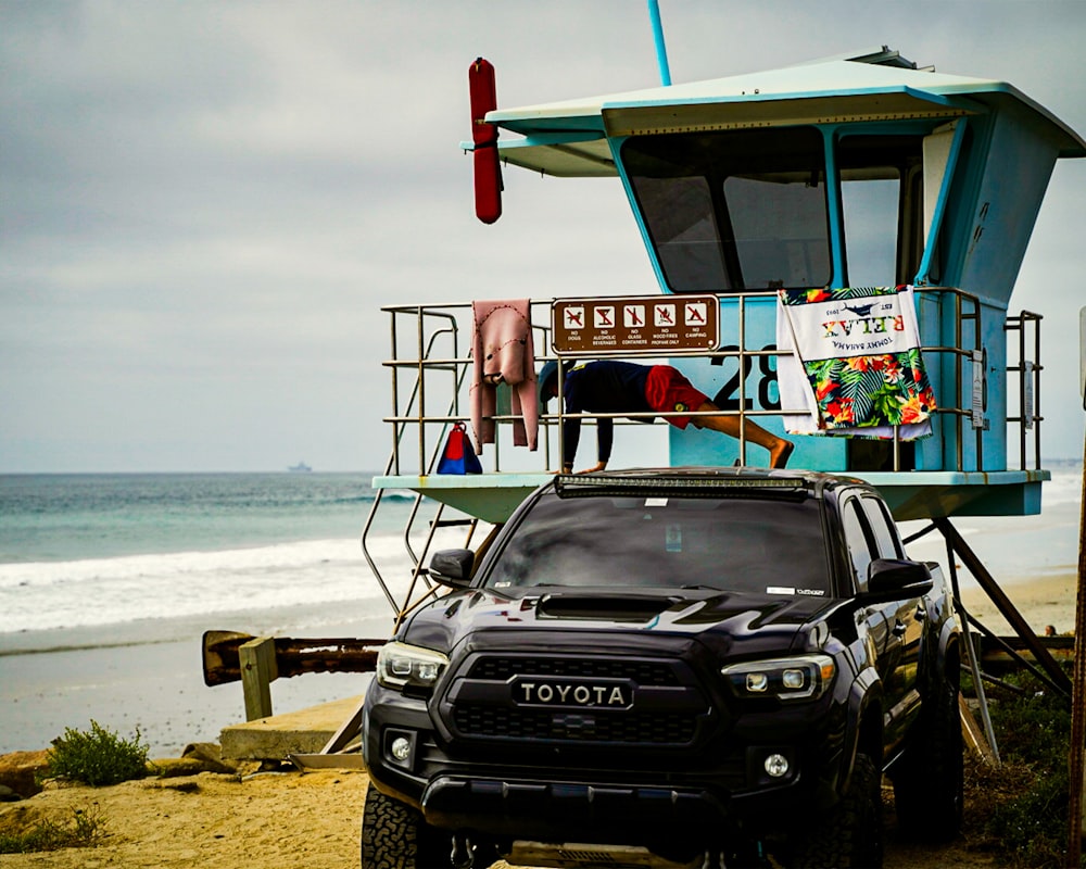 a truck parked in front of a life guard tower