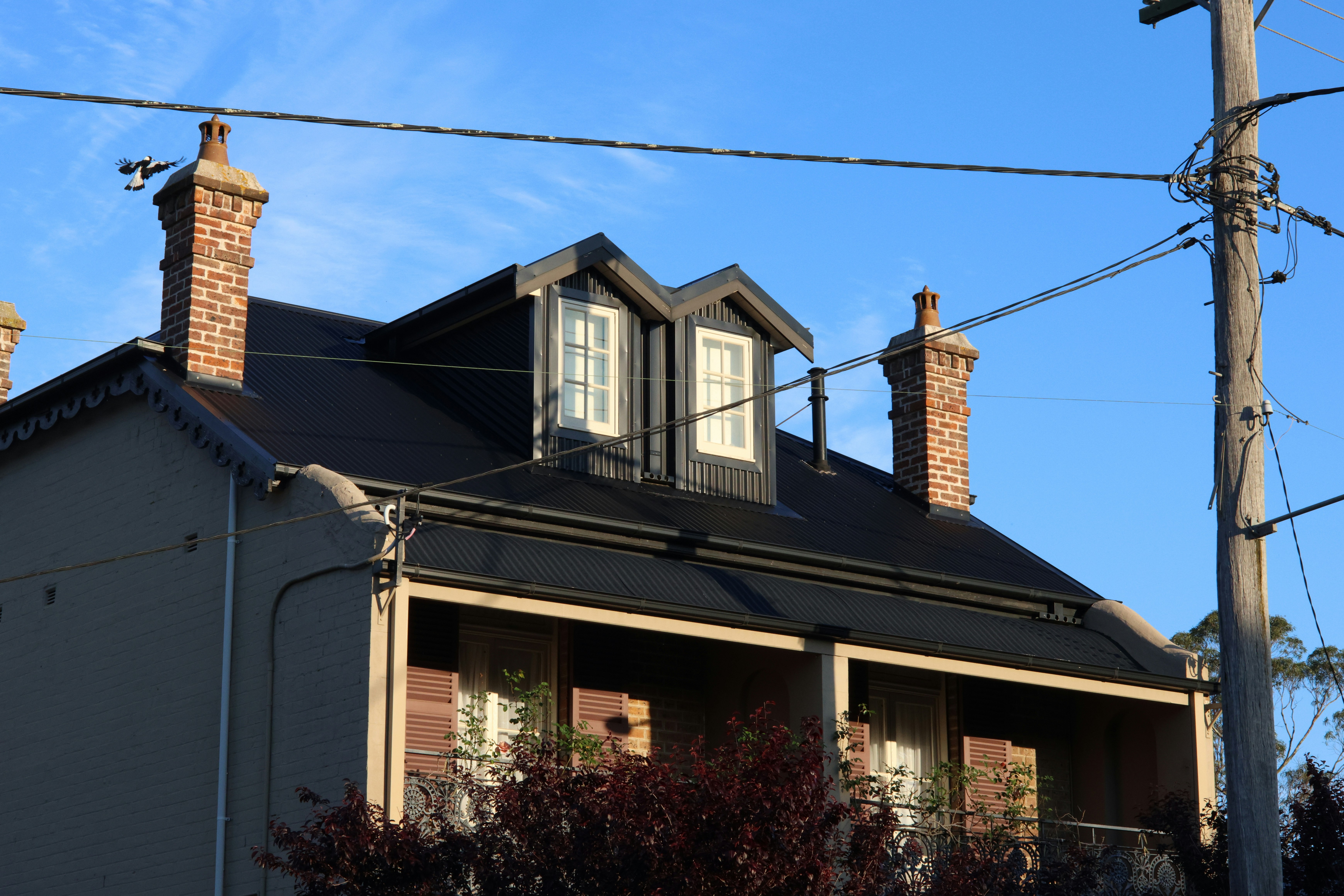 The exterior of a modern suburban home with clean architectural lines and a manicured front lawn, showcasing desirable curb appeal.