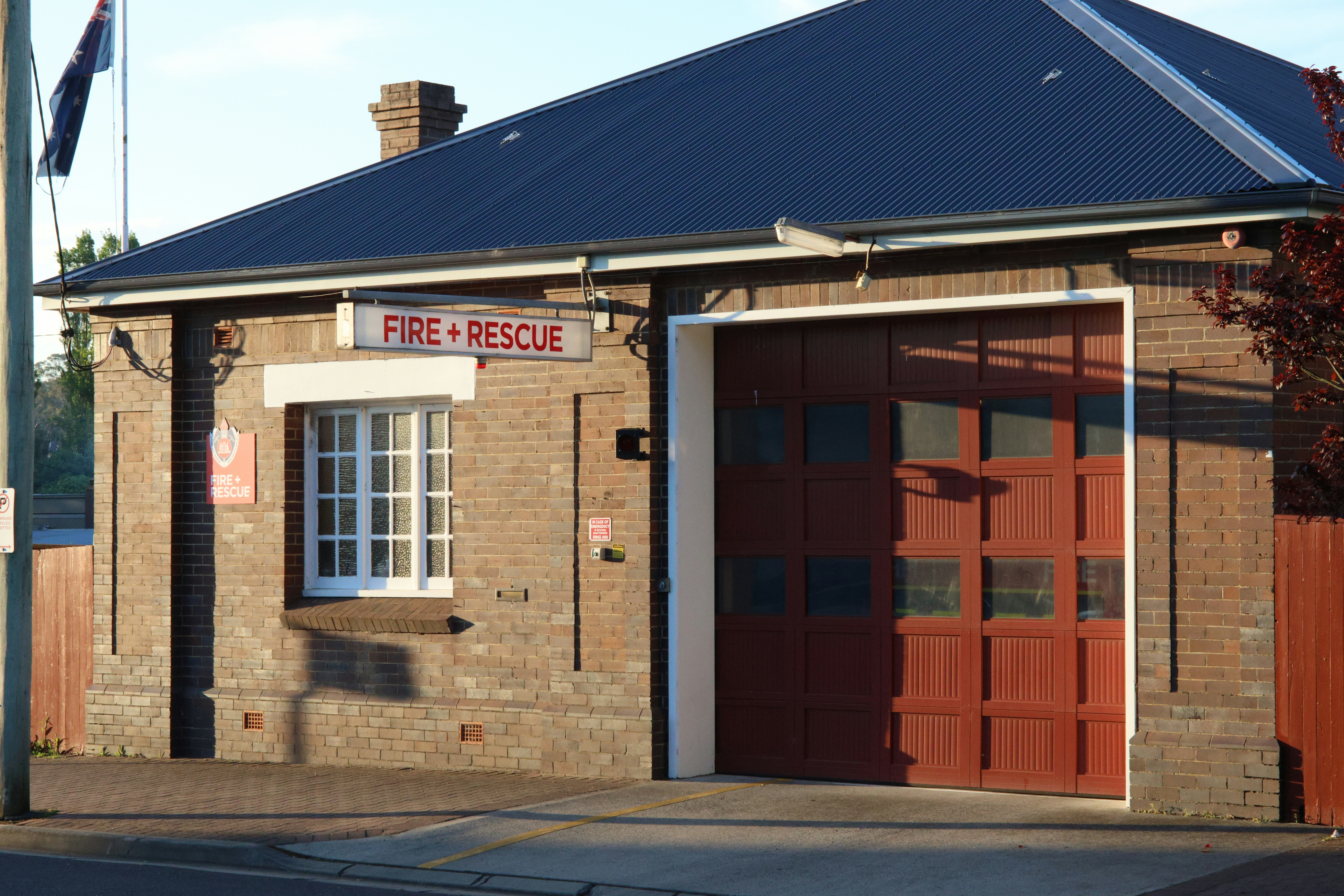 a brick fire station with a red fire hydrant