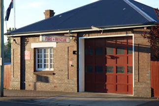 Photo of Ary Fire office entrance with clear signage and a modern dark exterior accented by red lighting.