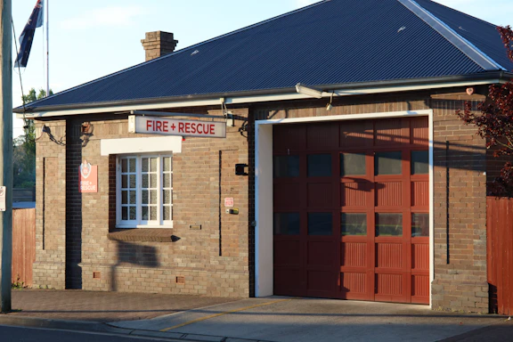 Photo of Ary Fire office entrance with clear signage and a modern dark exterior accented by red lighting.