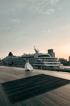 Elegant concierge assisting a couple with cruise planning in a luxurious setting