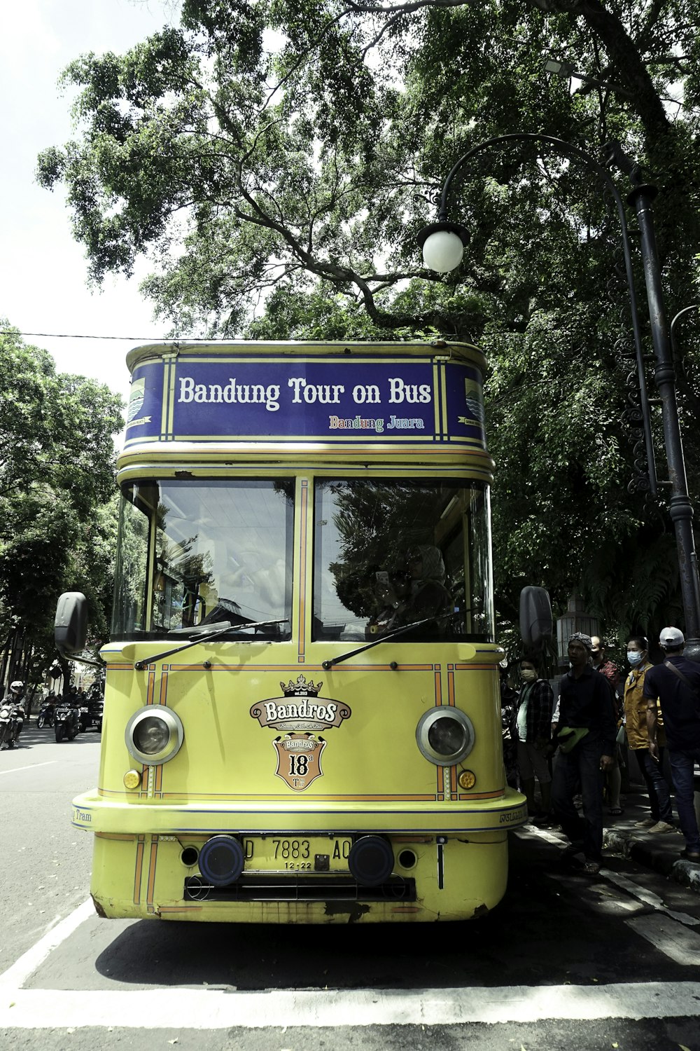 a yellow tour bus parked on the side of the road