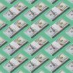 a lot of money sitting on top of a green surface