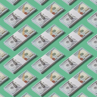 a lot of money sitting on top of a green surface