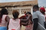 A coach guiding a group of athletes during a training session, emphasizing teamwork and support.