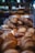 A variety of artisan breads are displayed in a bakery setting. The loaves have a rustic appearance with golden-brown crusts, some dusted with flour. They are arranged in a pyramid shape, creating a visually appealing display under soft lighting.