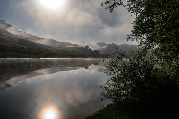A serene view of the Lake District's rolling hills under a soft morning mist.