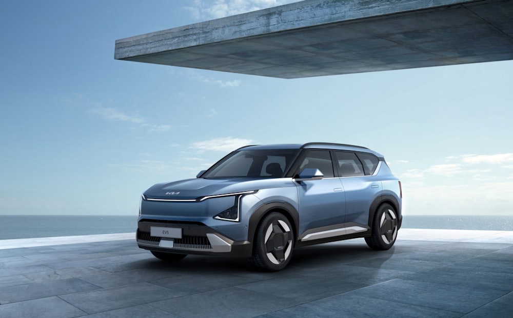 a blue suv parked in front of a building