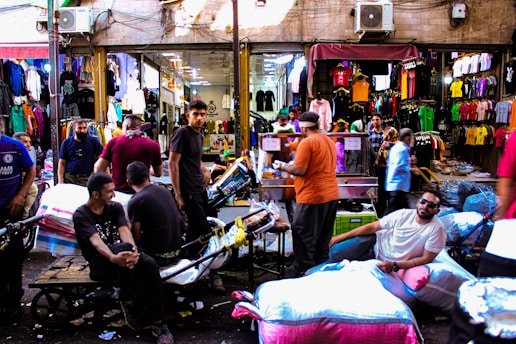 A vibrant marketplace scene with various shops and people interacting.
