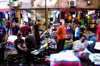 A lively marketplace scene showing diverse sellers and happy customers browsing and exchanging goods online.