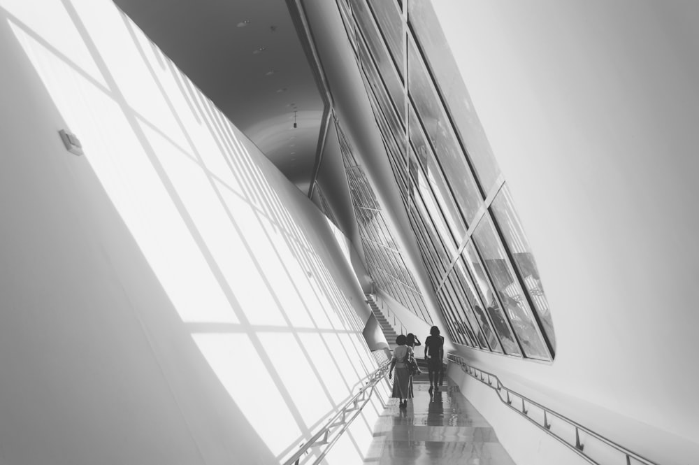 a couple of people that are standing in a hallway