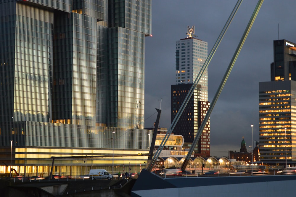 a city skyline with tall buildings and a crane