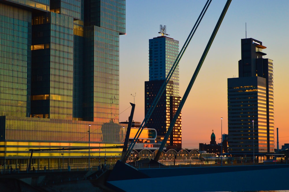 a boat is docked in front of some tall buildings